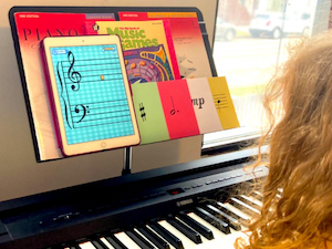 little girl looking at piano curriculum
