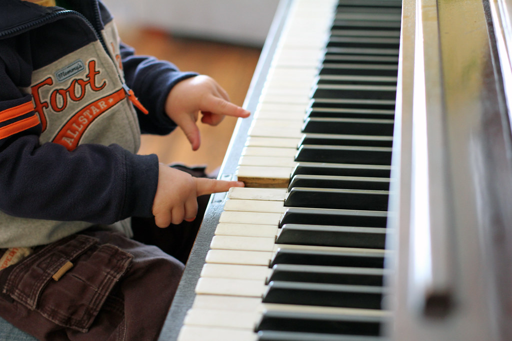young child playing the piano